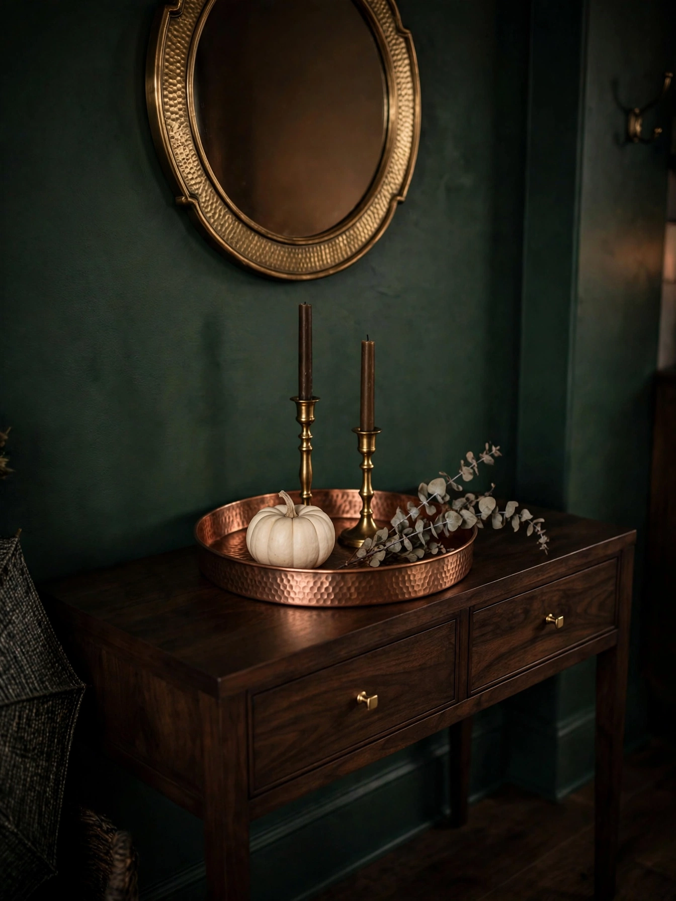 Fall entry table decor ideas for autumn 2026: a hammered copper tray with a white pumpkin, brass candlesticks and eucalyptus on a walnut console.