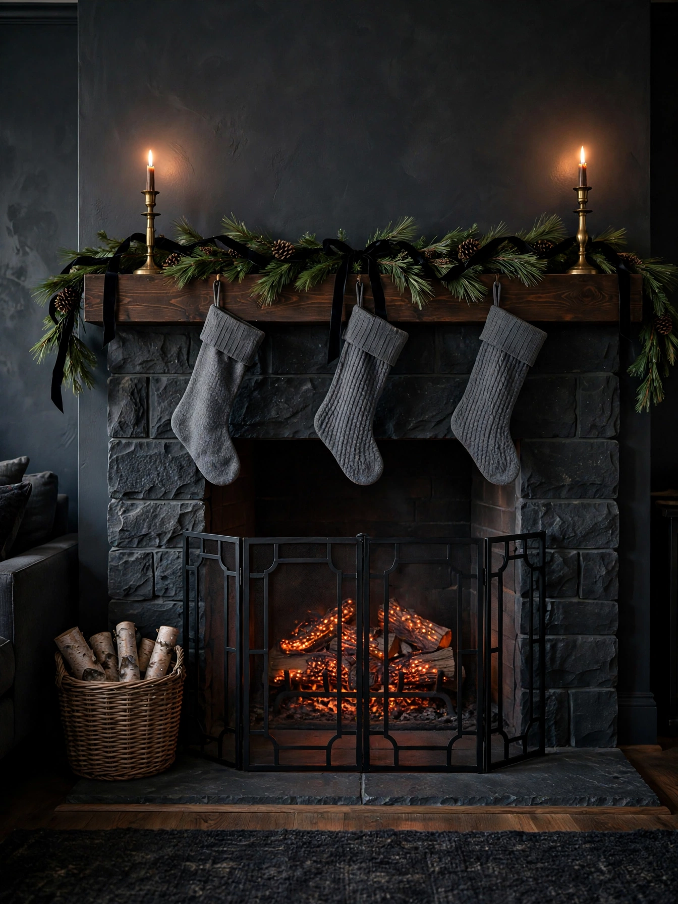 Fireplace with glowing ember effect logs, dark stone surround, and pine garland on the mantel, a warm moody christmas decor ideas 2026 hearth