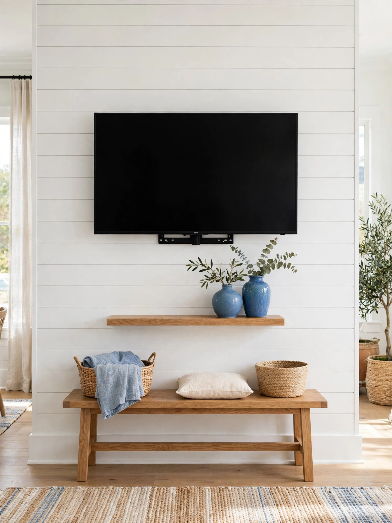 Wall-mounted TV with floating oak shelves styled with books and ceramics, airy tv wall ideas